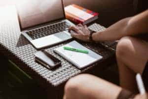 freelance designer working on laptop outside on terrace picjumbo com