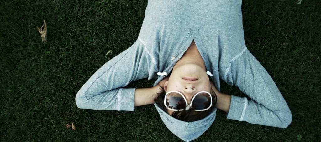 college student sleeping in field