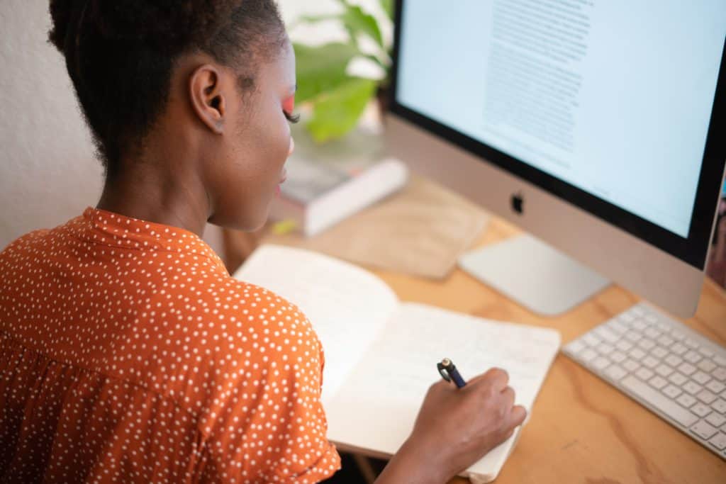 woman writing on her notebook 3059747