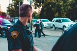 man wearing black officer uniform 1464230 scaled
